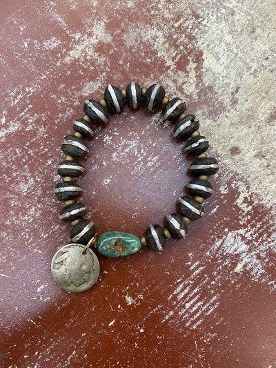 This photo is of the Hand Carved Wood with Silver Inlay and Kingman Turquoise Stretch Stacker Bracelet with Buffalo Nickel. This image was taken at the J.Forks Designs Boutique in downtown Boerne, Texas. 